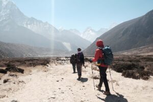 Trekkers hiking toward Himalayan peaks on the Everest Base Camp trail in Nepal