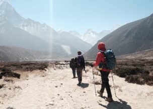 Trekkers hiking toward Himalayan peaks on the Everest Base Camp trail in Nepal