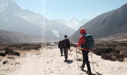 Trekkers hiking toward Himalayan peaks on the Everest Base Camp trail in Nepal